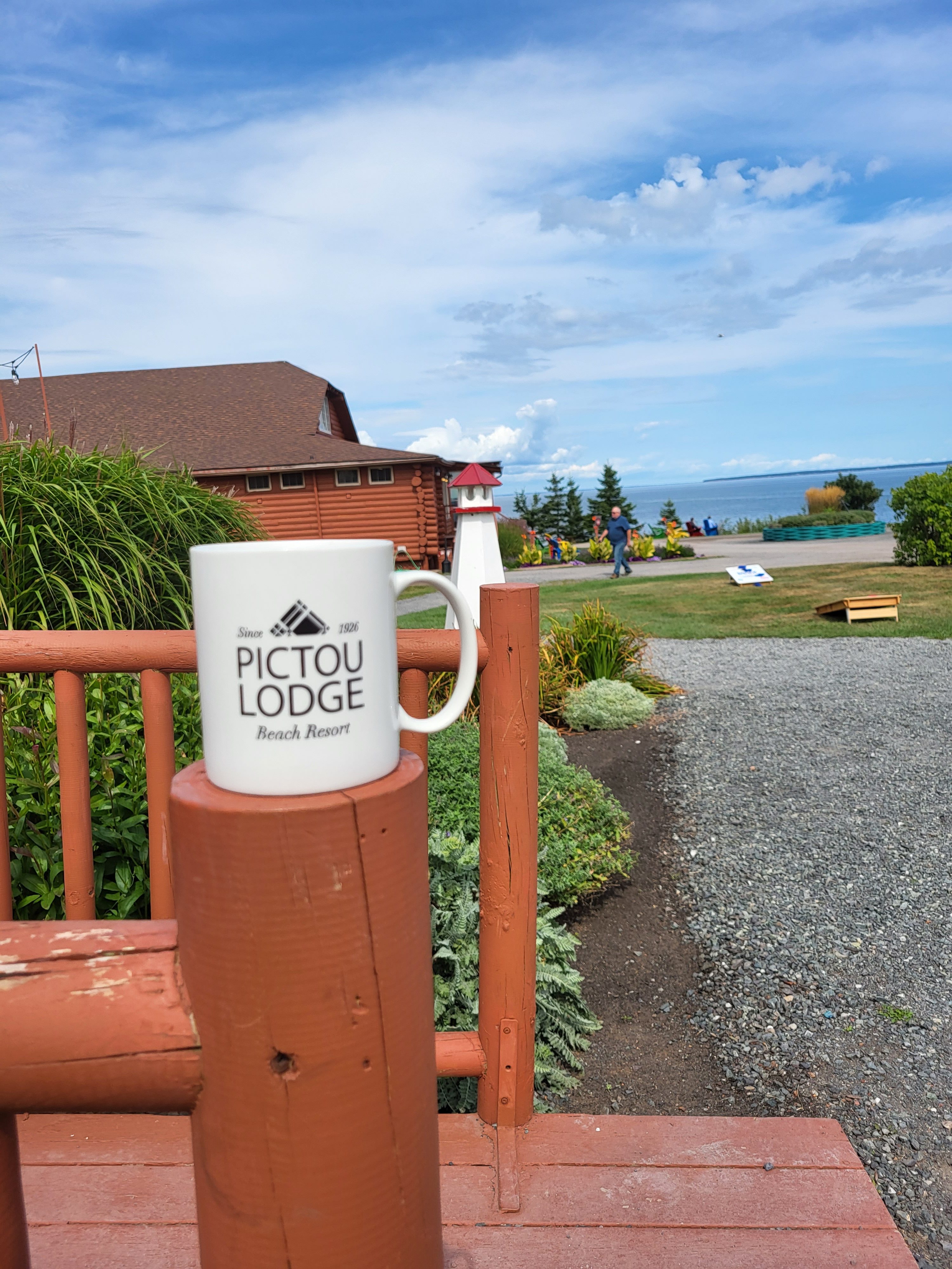 Pictou Loudge mug in front and ocean in the back